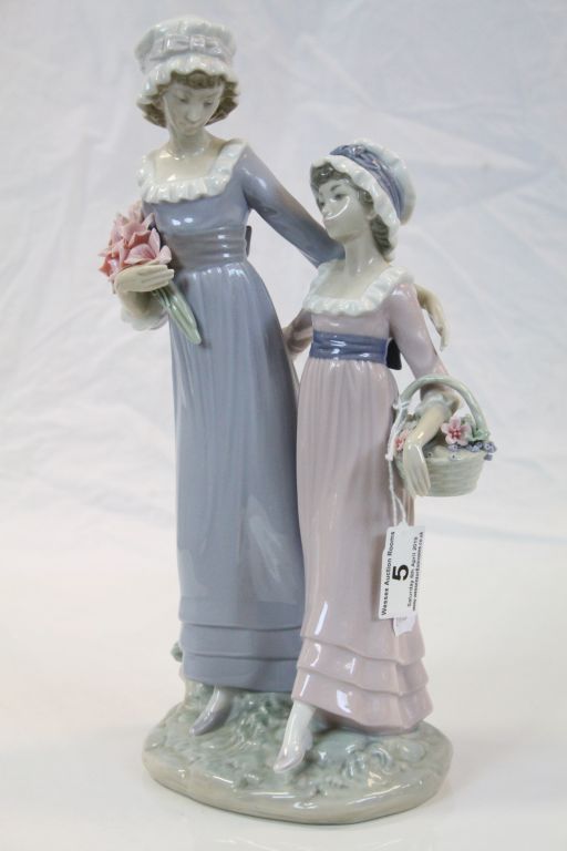Large Lladro ceramic figurine of "Daughters", both carrying flowers and standing approx 32.5cm