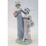 Large Lladro ceramic figurine of "Daughters", both carrying flowers and standing approx 32.5cm