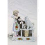 19th century Continental Ceramic Match Holder and Striker in the form of a Girl with a Cat and