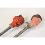 Two Papier mache painted Puppet heads on sticks, a female and a Devil, both approx 52cm long