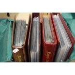 Four red Royal Mail binders with a quantity of GB FDI Covers in protectors and an envelope with 6 GB