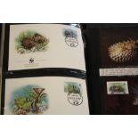Two albums of World Wildlife Fund featuring 1980s photo cards with stamps and covers