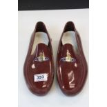 Pair of Vivienne Westwood Burgundy Rubber Shoes with attached enamel Orb logos, the souls and in-