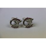 Pair of silver horseshoe shaped cufflinks set with rubies