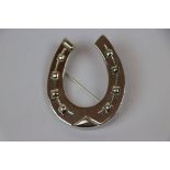 Large silver horseshoe shaped brooch