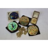 Four vintage compacts, three yellow metal necklaces and a French brooch