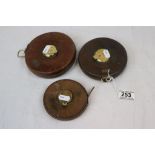 Three leather cased tape measures comprising 100Ft with engraved name R.A. Riddle and two 66ft (3)