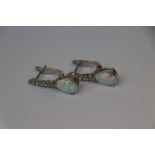 Pair of silver and pear shaped opal earrings