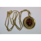 Vintage Yellow metal Pendant, set with faceted Smokey Quartz, and chain with marks to clasp, pendant