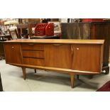 1970's Teak Sideboard with Three Drawers and Drop Front Cocktail Cupboard flanked either side by Two