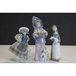 Three Lladro ceramic Figurines to include a Girl with a Basket of Kittens and another holding a Pig,