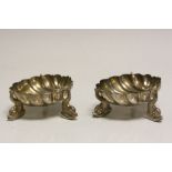 Pair of silver plated salts of shell form with dolphin feet