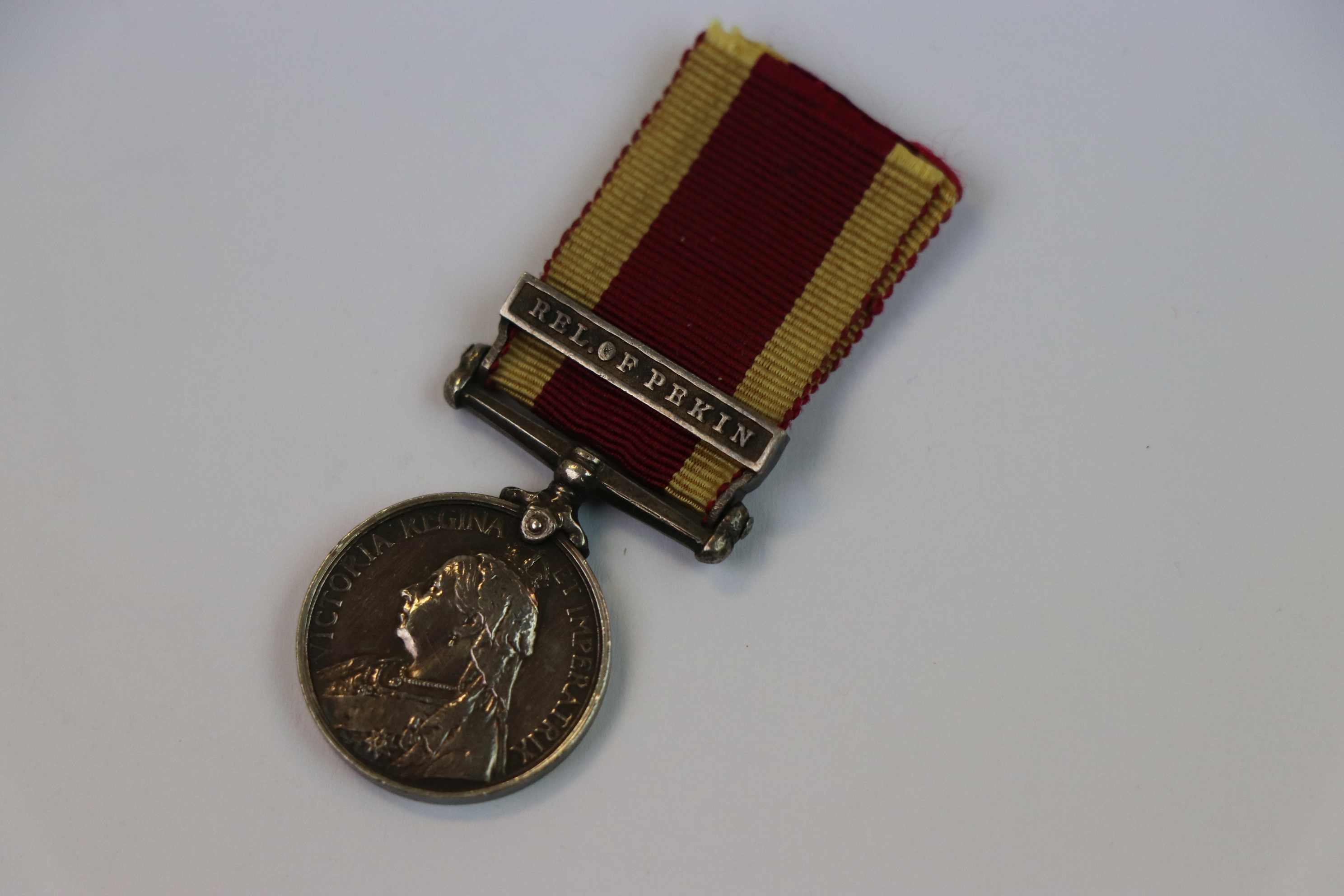 A Victorian British China War Of 1900 Miniature Medal With Relief Of Pekin Bar.