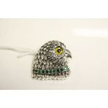 Silver brooch in the form of an owl with glass eye and emerald collar