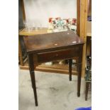 Early 20th century Oak Sewing Machine Table, the double hinged lid opening to reveal a rising