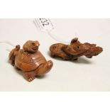 Two wooden netsuke figures to include tortoise with frog and mouse carrying tortoise