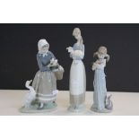 Three Lladro ceramic Figurines, one with Cats, another with Ducks and the third with a Lamb, tallest