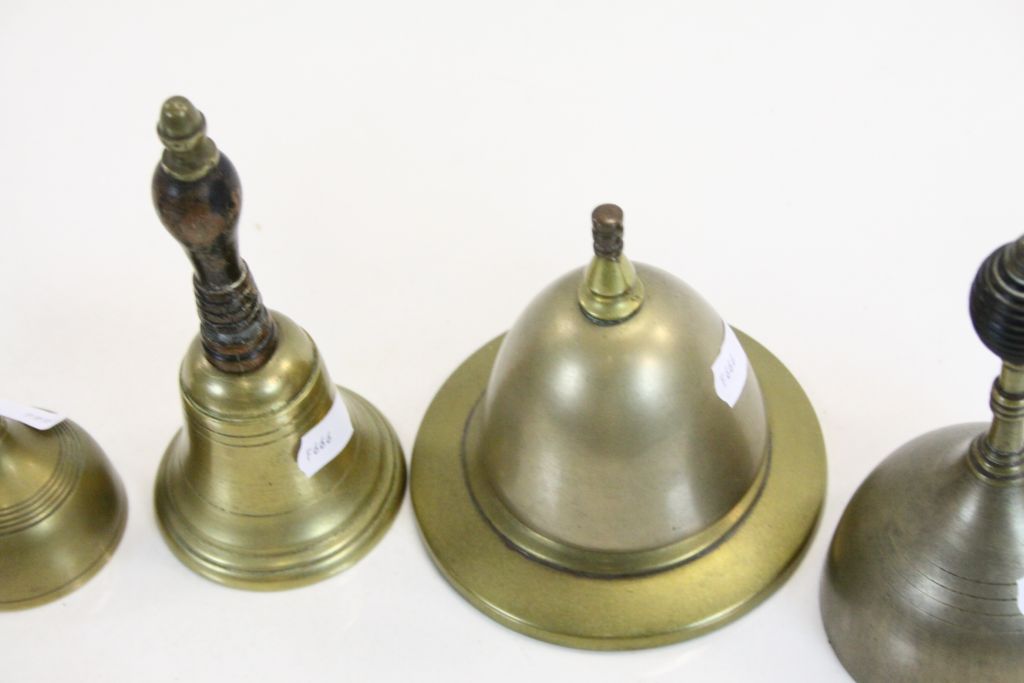 Four vintage Bronze hand Bells with ebonised Wooden handles plus a similar Counter top example - Image 3 of 4