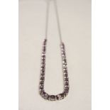 Hallmarked Silver necklace set with approx 32 faceted Amethyst stones