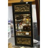 Oriental Ebonised Wall Mirror with Carved Scenes of Figures, 59cms x 27cms