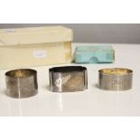 Three Hallmarked Silver Napkin rings in different designs, one with Box