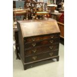 Georgian Oak Bureau, the hinged fall front opening to reveal a fitted interior above Four Drawers