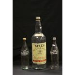 Empty Bells Whiskey 4.5 Litre Bottle together with Two Empty Glass Coca Cola Bottles plus a Coat