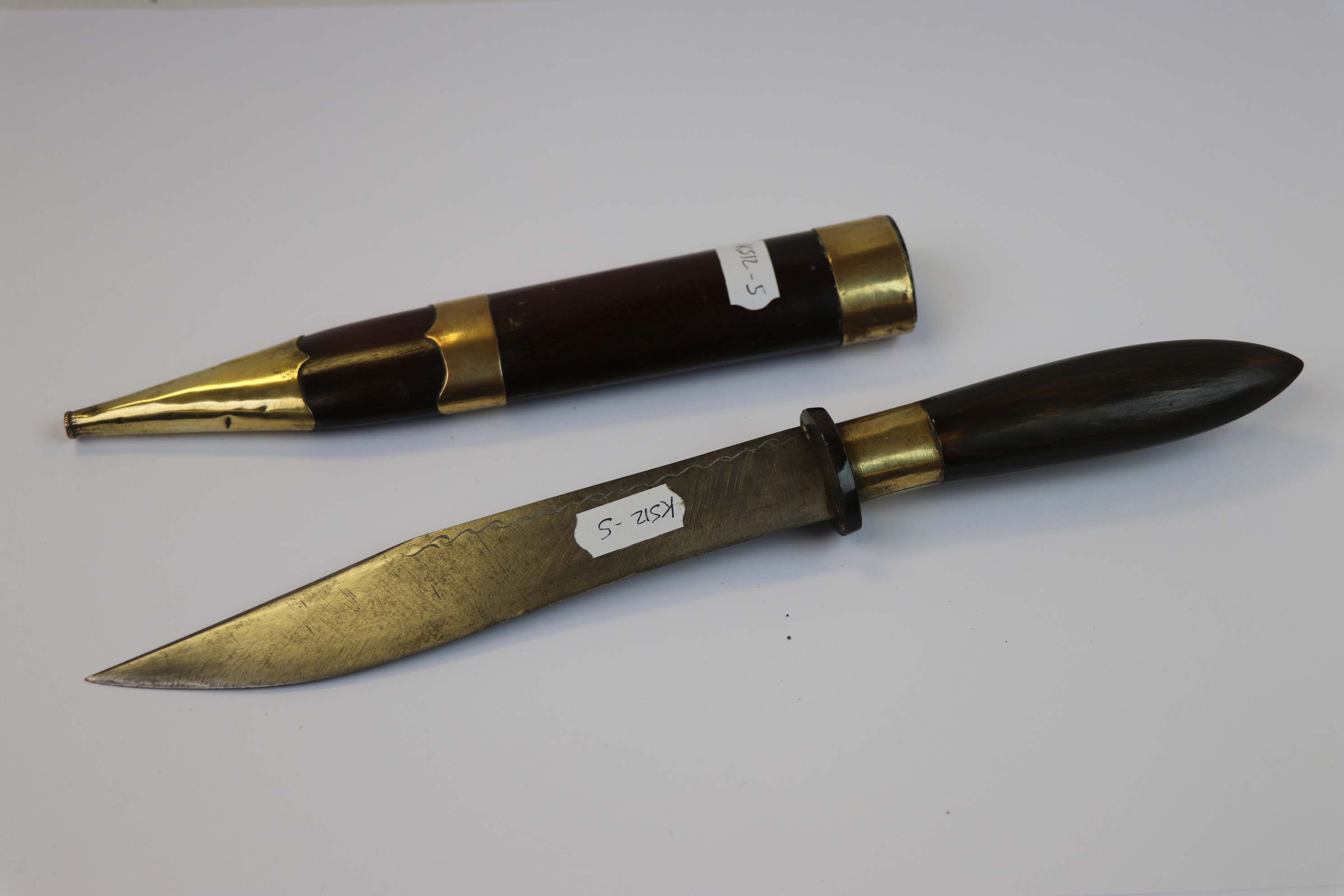 A Vintage Malayan Dagger With Wood And Brass Sheath.