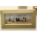 Gilt framed oil painting of a Victorian beach scene with ladies and parasols