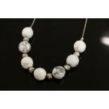 Silver and faceted bead necklace with silver spacers