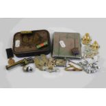 A Small Collection Of Militaria To Include A Selection Of Military Badges, A Trench Art Lighter, A
