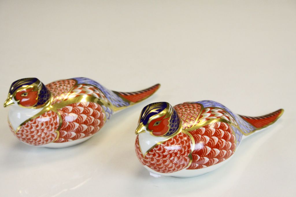 Pair of Royal Crown Derby Pheasant Paperweights, one numbered XLIX with no stopper, the other