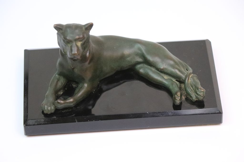 Patinated Bronze model of a Lioness on Deco style black base, approx 14 x 7.5 x 7cm at the widest