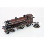 Early 20th Clockwork locomotive, unmarked, with key, some wear with loose wheel, in maroon