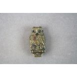 Antique brass versa in the form of an owl with glass eyes