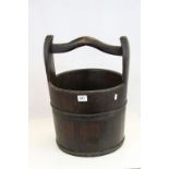 A vintage coopered wooden bucket.