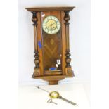 An antique viennese style two train wall clock.