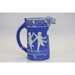 Antique Jasperware jag with dancing children decoration and a rams head spout