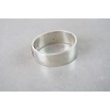 A vintage hallmarked silver cuff bangle with leaf decoration to one side.