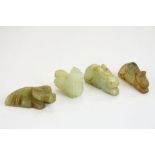 A collection of four oriental carved jade animals.