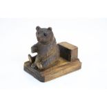 A hand carved black forest bear matchbox holder.
