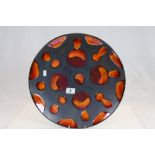 Large Poole Pottery 'Galaxy' Charger, black ground with Lava red Circle design with decorators marks