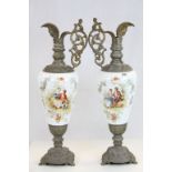 A pair of large continental opaque glass and metal ewer jugs with young lovers..