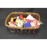 A wicker basket containing a quantity of Toys including Trolls and other figures.