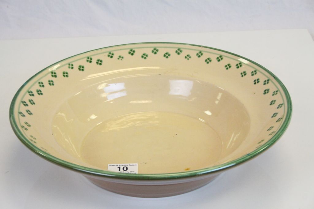 Slipware Bowl decorated with a cream glaze and green decoration, 36cms diameter