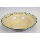 Slipware Bowl decorated with a cream glaze and green decoration, 36cms diameter