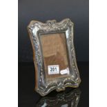 A hallmarked silver photograph frame measuring approx 8.5" x 6.5" with an aperture of approx 5" x