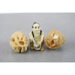 Two Oriental carvings of fruit plus a resin netsuke type figure of a basket maker