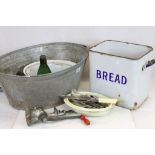 A galvanized steel wash tub together with an enamel bread bid and glass bottles.