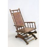 Late 19th / Early 20th century American beech Rocking Chair with turned supports.
